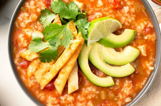 Chicken tortilla rice soup with avocado and lime