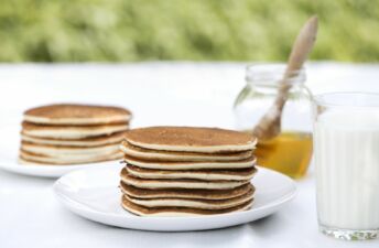 stack of fluffy rice pancakes with syrup